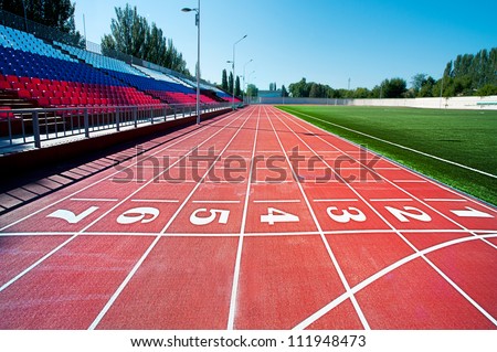 Red treadmill at the stadium with the numbering from one to seven