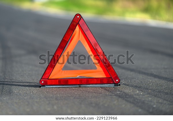 Red triangle of a car on\
the road