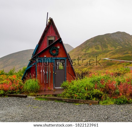 Red Triangle Dry Cabin In Hatcher Pass Surrounded By Mountains Full Of Fall Colors On A Rainy Day In Alaska