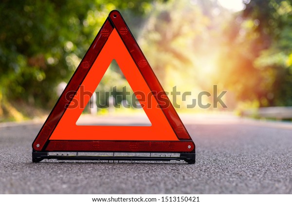 Red triangle, red emergency stop sign, red\
emergency symbol on road.