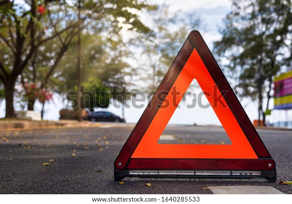 Red triangle, red\
emergency stop sign, red emergency symbol on road. With copy space\
for text or design