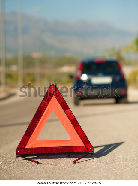 Red triangle\
on the road to signal a\
breakdown