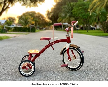 Red tricycle white wheels. Classic vintage childhood bicycle. Traditional tricycle