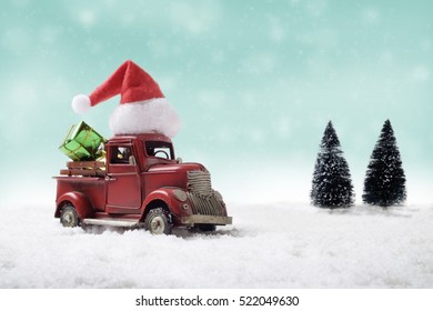 Red truck toy carrying a christmas gift on sweet pastel retro turquoise color background. - Powered by Shutterstock