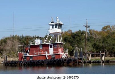 A Red Tugboat Docked On Bayou Lafourche In Southern Louisiana.