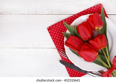 Red tulips, on white plate. Romantic valentines day background. Love top view with copy space for text