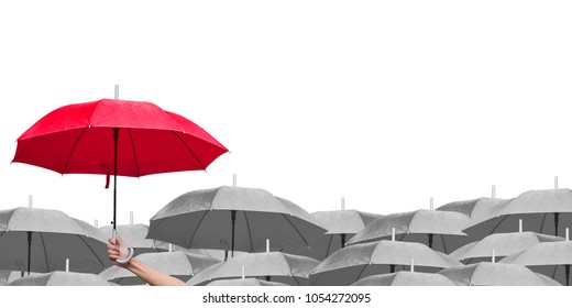 red umbrella over dark umbrellas on white background. The difference to step up to leadership in business.hand of man holding a red umbrella in raining. side view.