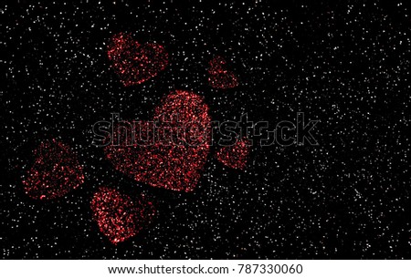 Red Valentine's day hearts that are faded shown with a glittery black background with white dots