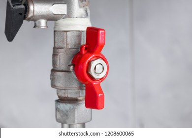 Red valve that provides water supply.