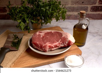 Red Veal Chop On A Plate On A Wooden Board