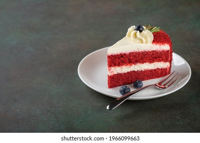 Red Velvet cake with blueberries on white plate over dark green background. Copy space. - Powered by Shutterstock