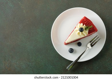 Red Velvet cake with blueberries on white plate over dark green background. Copy space, top view. - Powered by Shutterstock