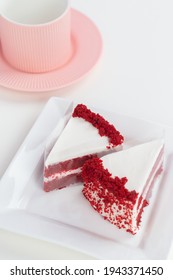 Red Velvet Cake On A White Table With A Pink Tea Mug