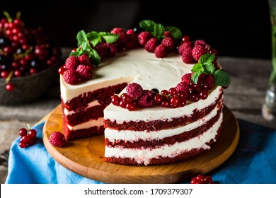 Red velvet cake on wood board. Slice of cake. Raspberry cake. Devil's cake. Wedding dessert. Birthday party. Delicious dessert. Traditional american dessert