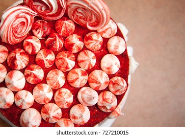 Red Velvet Cake Is Painted With Many Small Meringues. Photo From Above..