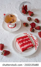 Red Velvet Cake With Strawberries On A Blue Plate With Tea