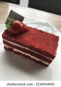 A Red Velvet Cake With The Strawberry Above