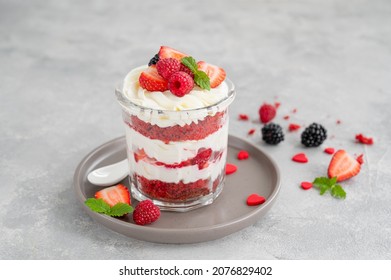 Red Velvet cake trifle with fresh berries in a glass jar on a gray concrete background. Dessert for Valentine's Day. Copy space - Powered by Shutterstock