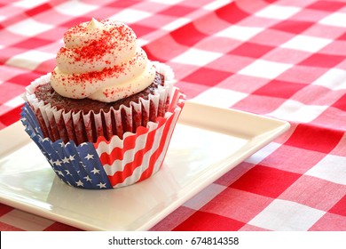 Red Velvet Cupcake In Horizontal Format With Patriotic Red, White And Blue Cupcake Liners On Red And White Checked Cloth