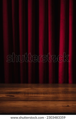 Red velvet curtains and wooden table