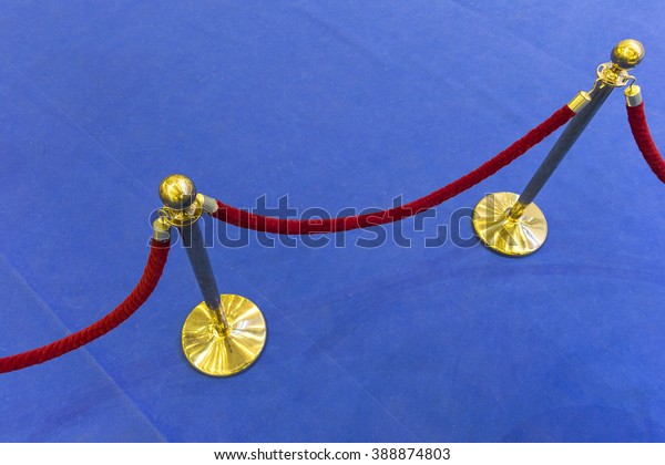 Red\
velvet rope and a blue carpet. Abstract\
background