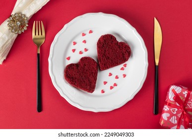 Red velvet sponge cakes in the shape of hearts on white plate