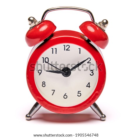 Red vintage alarm clock isolated on white background with clipping path