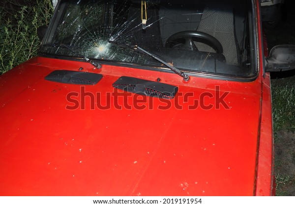Red\
vintage car in red color. A broken car\
window.