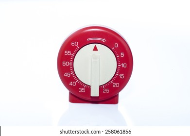 Red, vintage kitchen timer isolated on white background