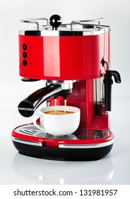 A Red Vintage Looking Espresso Coffee Machine Is Making A Coffee On A White Background