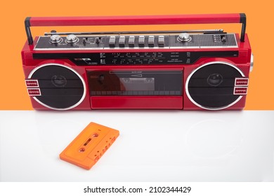 Red Vintage Tape Player Isolated On Orange And White Background