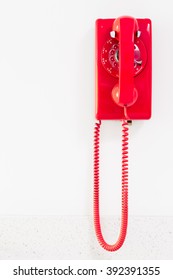 Red Vintage Telephone Hanging On White Wall