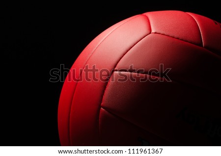 Red volley ball against a  black background