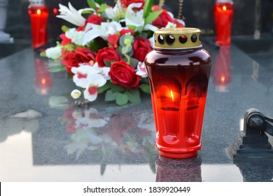 Red Votive Candle On The Grave 