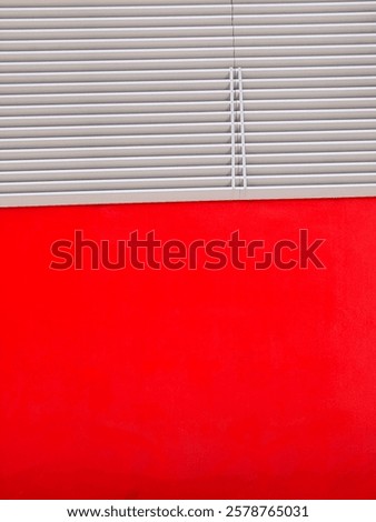 Red wall and a slanted aluminium cladding