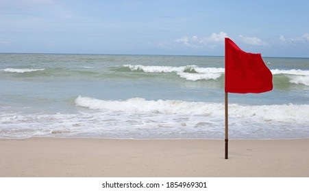 Red Warning Flag On Beach