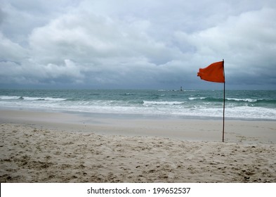 Red Warning Flag On Beach