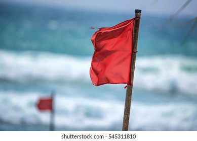 Red Warning Flag On Beach