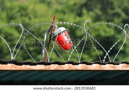 Red warning light with barbed wire on hazard zone