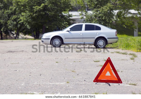 Red warning sign on\
the car background\
