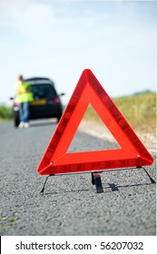 Red Warning Triangle With A Broken Down Car