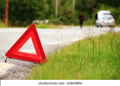 Red Warning Triangle With A Broken Down Car