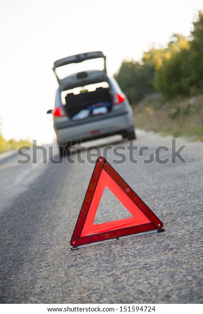 Red warning
triangle with a broken down
car