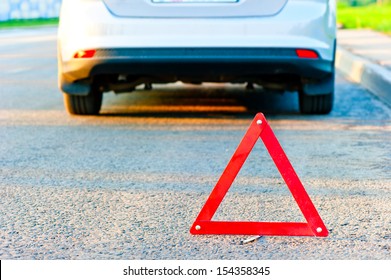 Red Warning Triangle And A Car Pull Over To The Side Of The Road