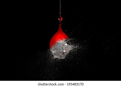 Red Water Balloon Explosion Burst Right After Penetration