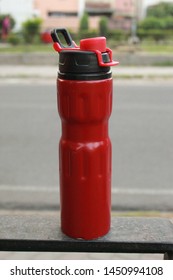 A Red Water Bottel With Red Cap Isolated