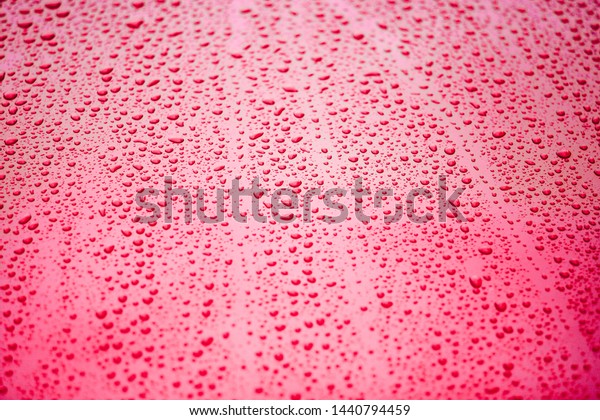 Red water drops\
raindrops on ceramic coated red\
car with hydrophobic effect