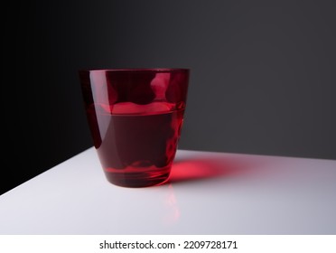 Red Water Glass Over A Black Background.vintage Glassware