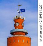 red water tower with clock hanko finland flags