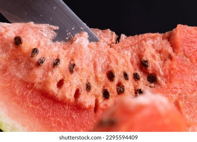 red watermelon cut into pieces on the table, juicy red watermelon pulp with seeds